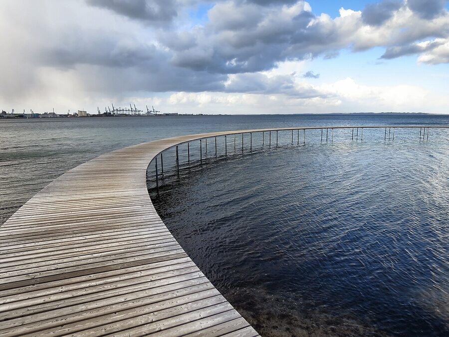 Walkers on Den Uendelige Bro, the circular pier south of Aarhus