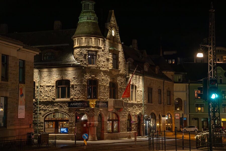 Illuminated Jugendstil building in central Ålesund at dusk