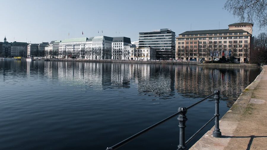 Reflection of Hamburg's architecture in the Alster Lake on a clear day