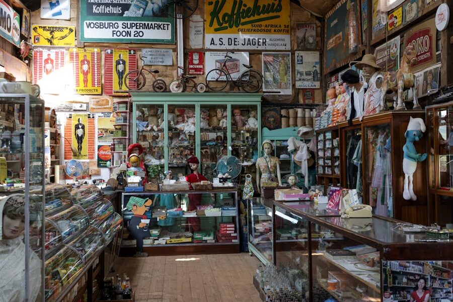 Interior of a vintage antique shop with shelves of old objects, signs, and collectibles