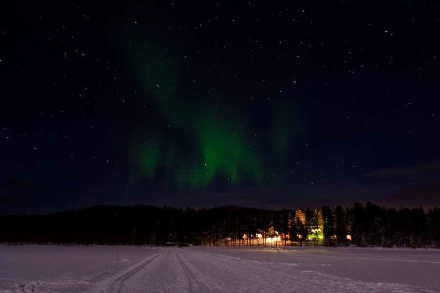 Aurora borealis illuminating a snowy landscape in Helukka