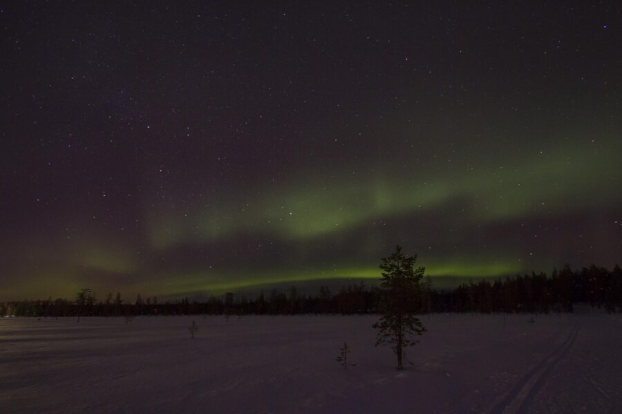 Aurora borealis over a snowy night in Finnish Lapland