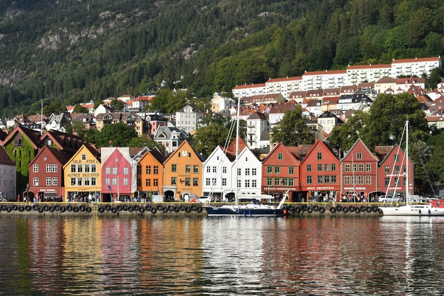 Bryggen waterfront on a clear day with cafe tables in the alleys