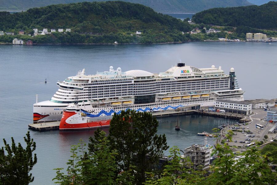 Cruise ships moored at Bergen harbour with mountains behind