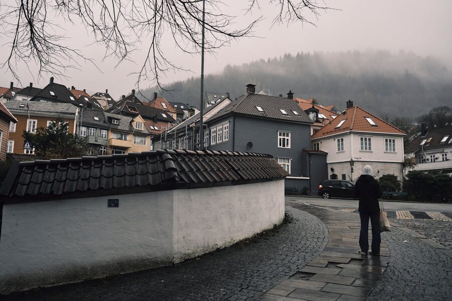 A misty quiet street in Bergen with colourful wooden houses