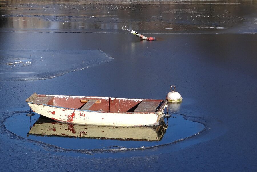 Christiania boat moored in winter on a frozen canal in Copenhagen