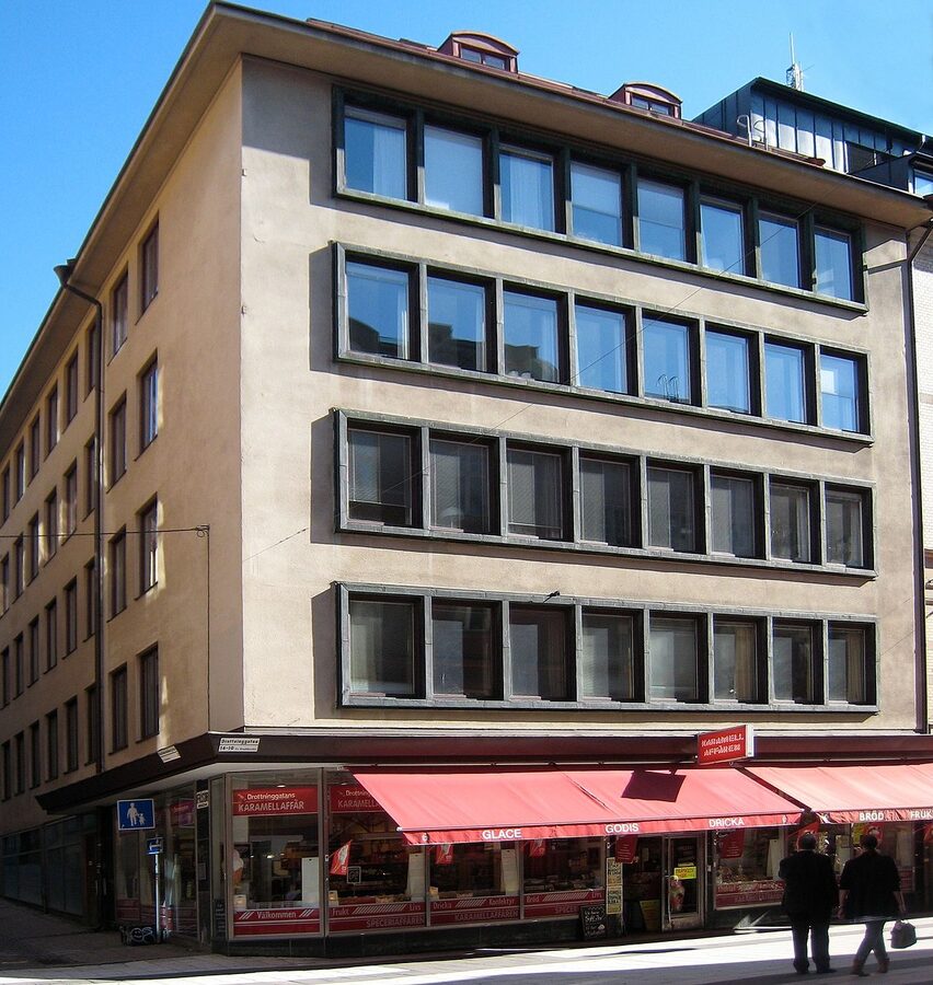 Drottninggatan pedestrian shopping street in Stockholm with people walking and historic facades