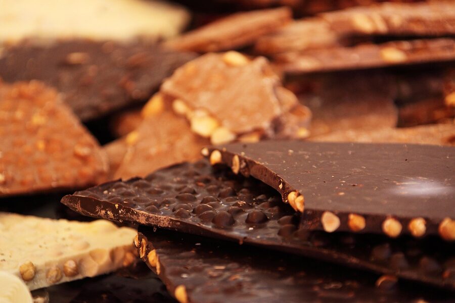 A selection of dark and milk chocolate bars on a white surface, the kind of confectionery sold at Brunberg