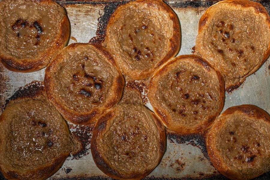 Top view of freshly baked Finnish pulla breads on a baking tray