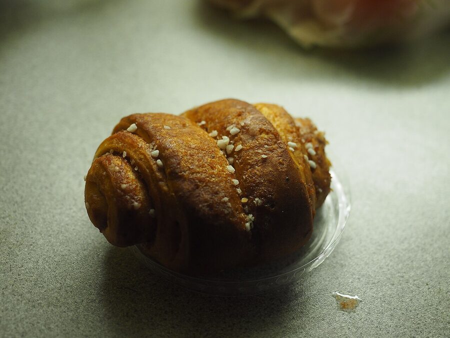 A classic korvapuusti, the Finnish cinnamon bun with crystal sugar topping