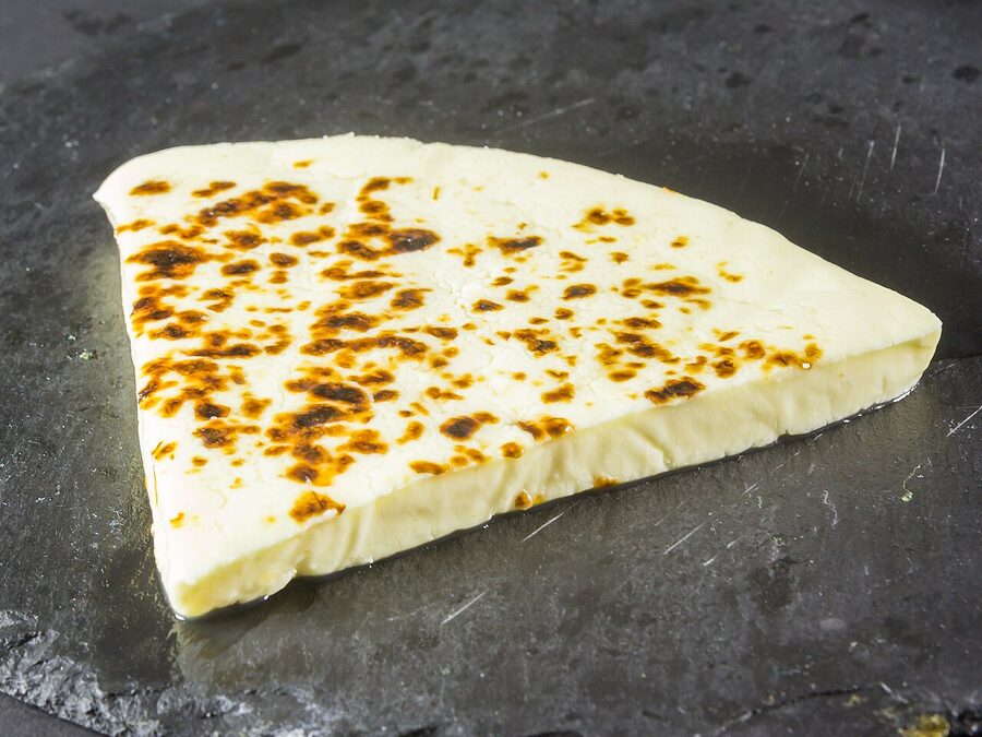 A block of leipäjuusto cheese, the brown caramelised surface visible