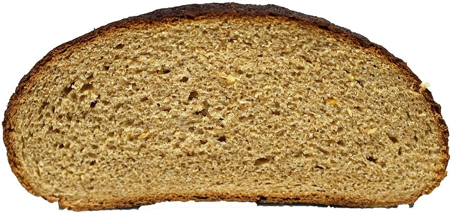 A round Finnish rye loaf on a wooden board, the dense limppu version