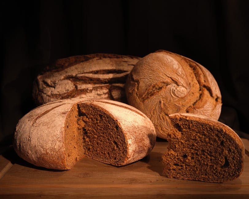 Freshly baked rye bread loaves on a wooden board