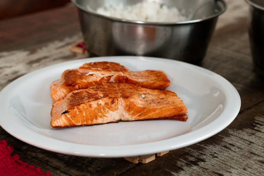 A close-up of cold-smoked salmon fillets on a white plate