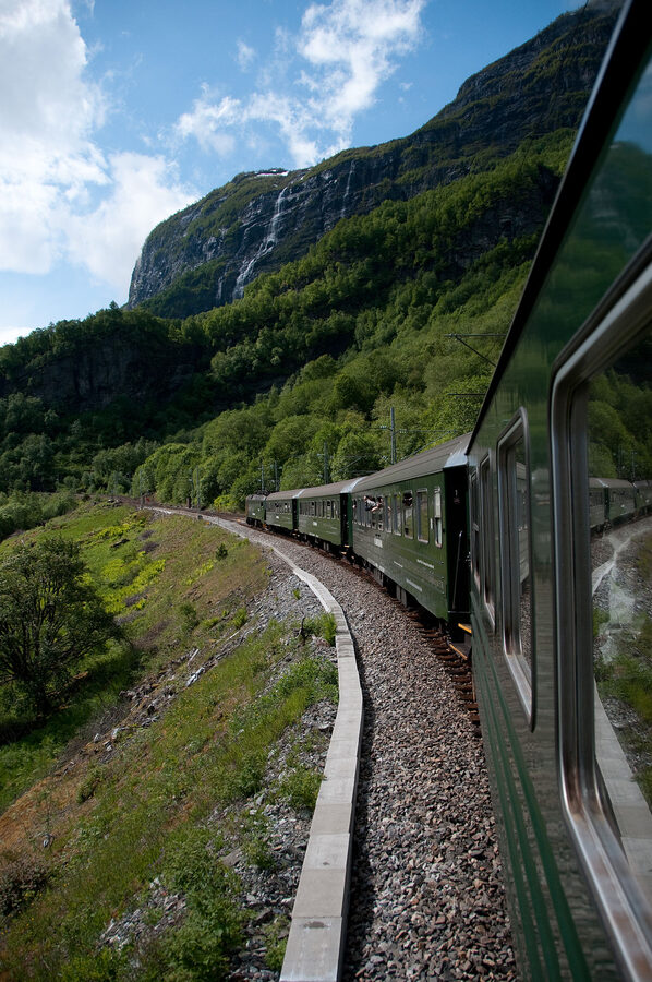 Flåm Railway train rounding a tight curve in the upper valley