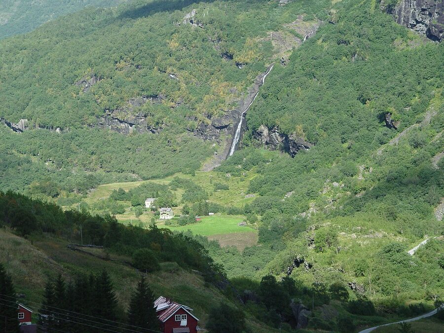 Flåm Railway green train descending through the upper Flåm valley