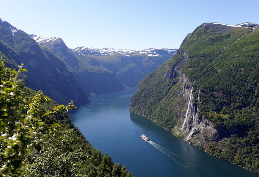 Cruise ship dwarfed by cliffs in Geirangerfjord