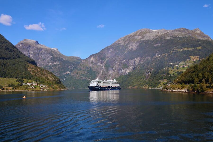 Cruise ship sailing between cliffs in Geirangerfjord, Norway