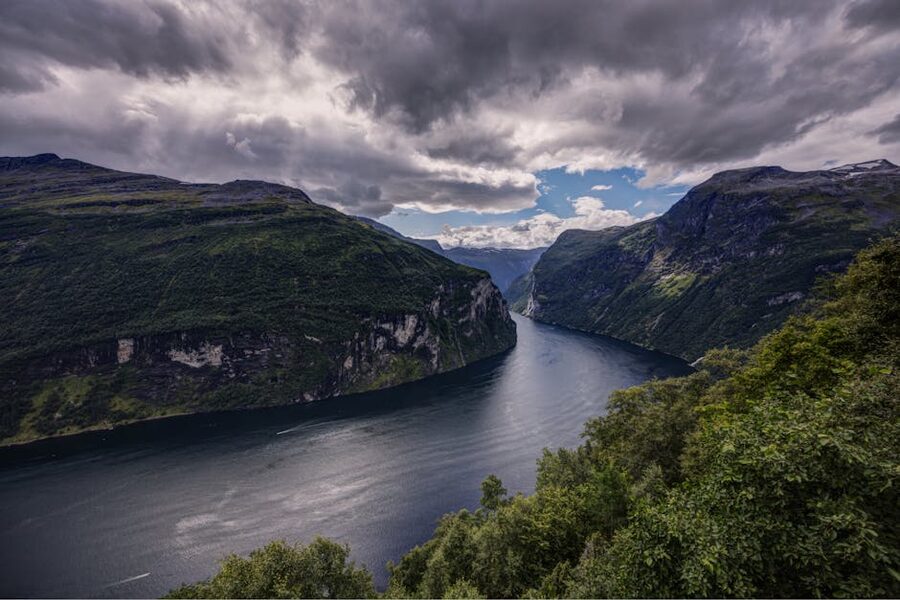 Geirangerfjord with cloud-shadowed cliffs in low light