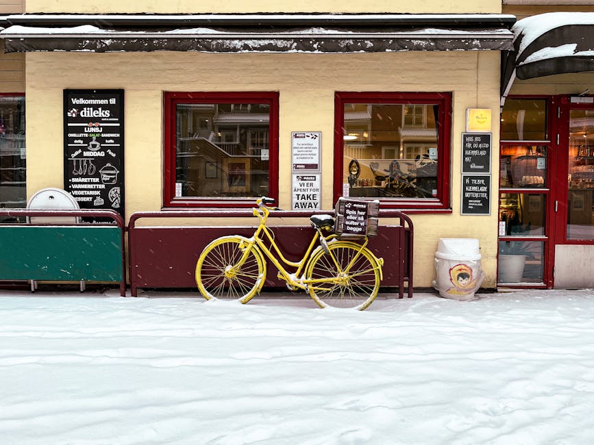 A yellow bicycle outside a Scandinavian café in winter