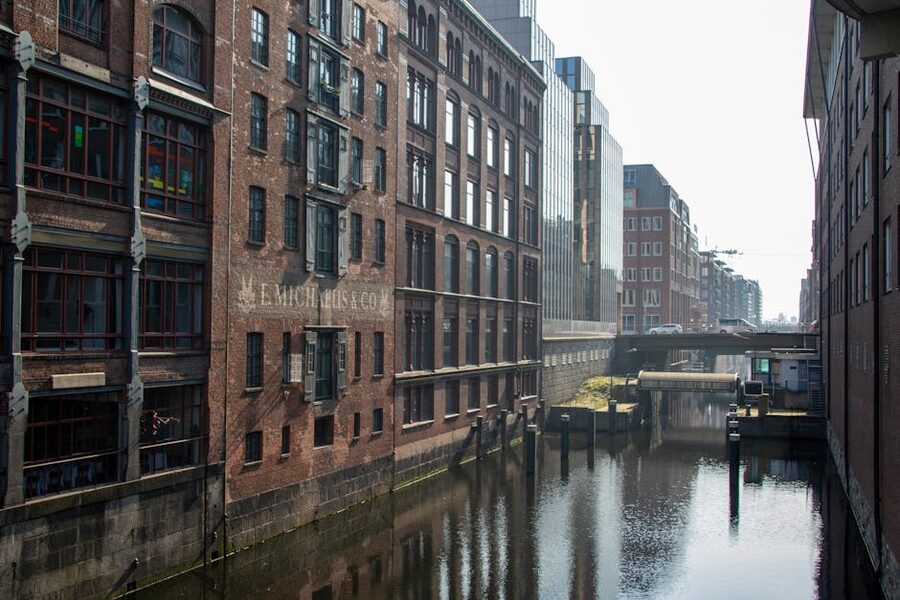 Brick warehouses along a quiet Speicherstadt canal in morning light