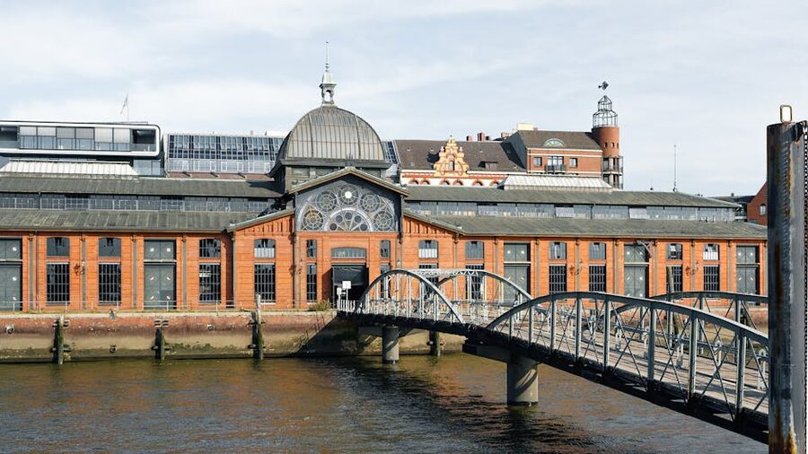 The historic Fischmarkt auction hall with arched bridge in the foreground
