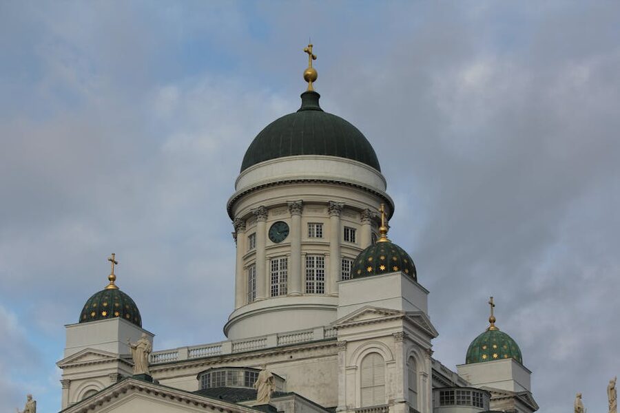 Close view of Helsinki Cathedral dome and towers under cloudy sky