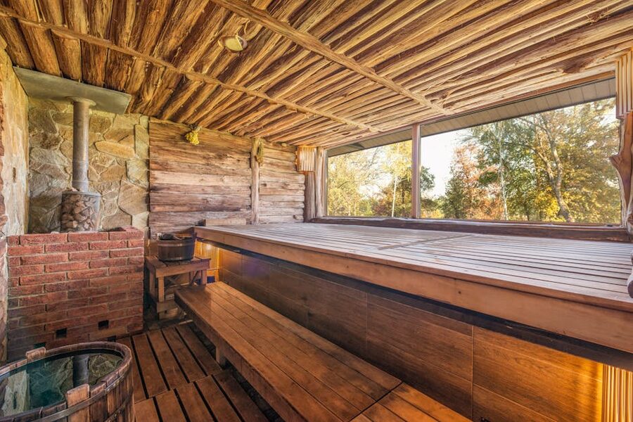 Wooden interior of a traditional Finnish sauna with bench and stove
