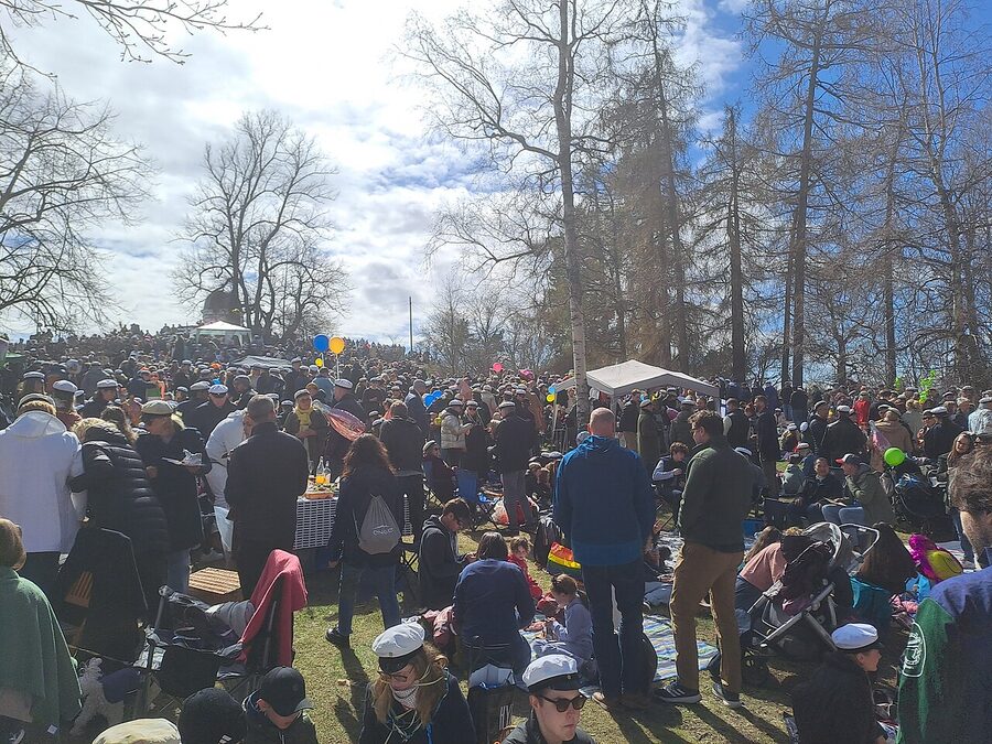 A May Day Vappu picnic at Kaivopuisto Park Helsinki, with people in white student caps