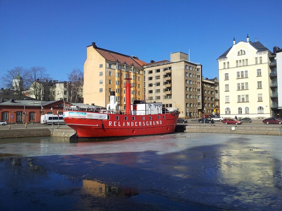 Helsinki bay in winter with a docked ship and snow on the shore