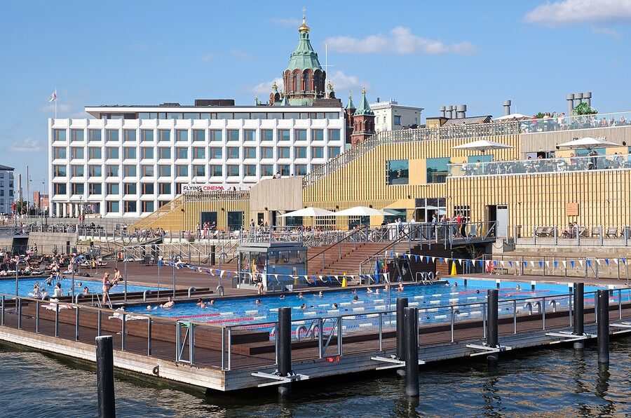 Allas Sea Pool sun deck with people in deck chairs