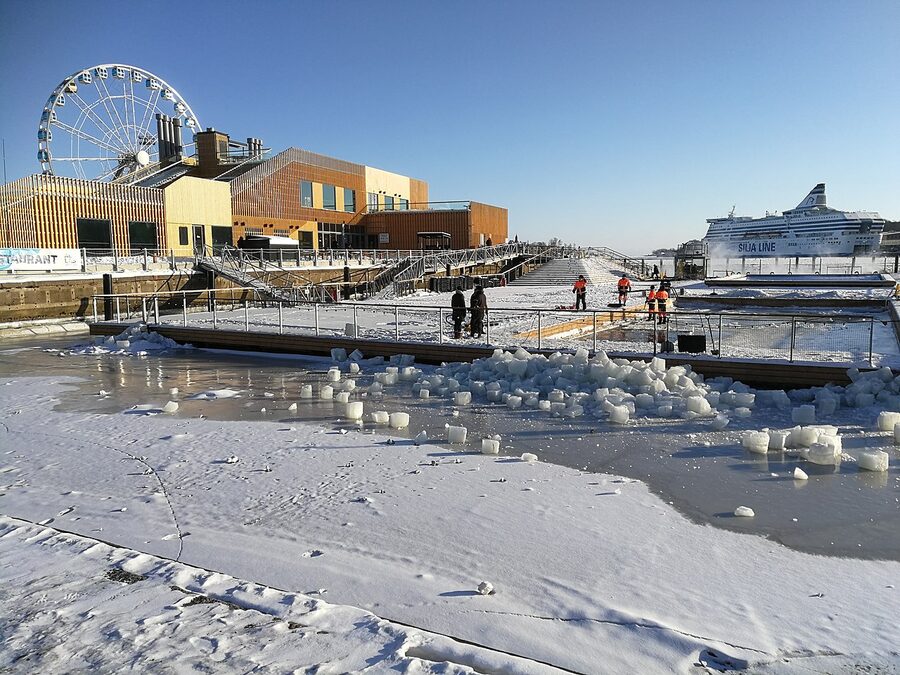 Allas Sea Pool in February with snow and steam rising off the warm pool
