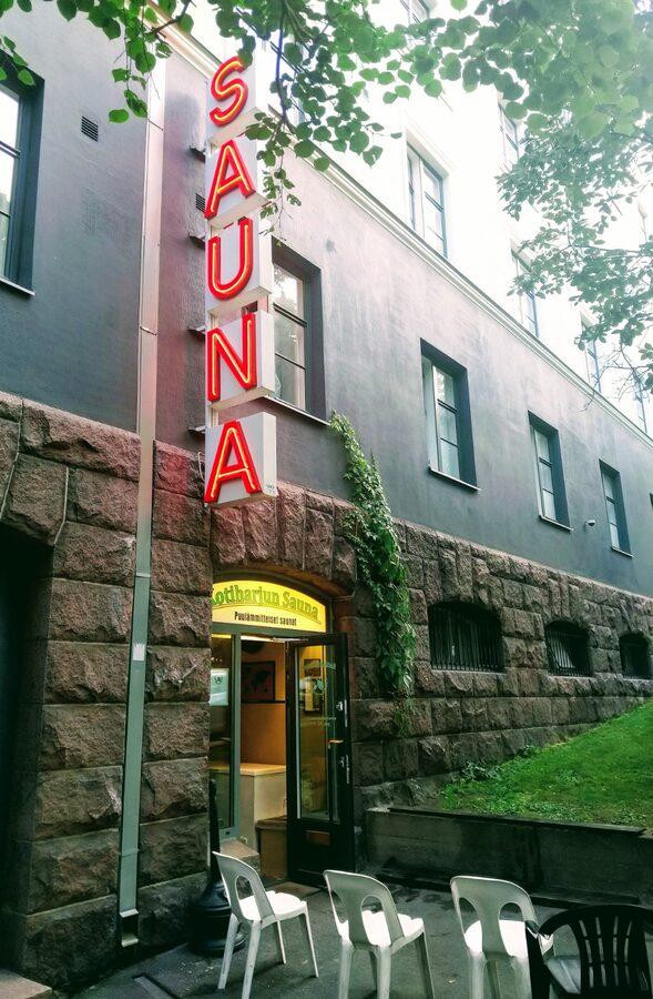 Kotiharju sauna front entrance with painted wooden door and small steps