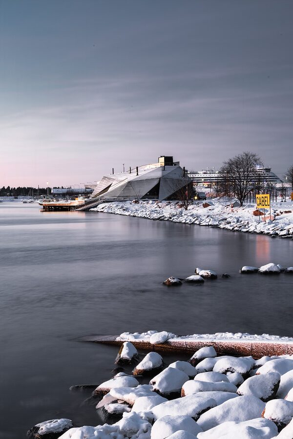 The Löyly sauna terrace from sea level, wooden steps rising out of the Baltic
