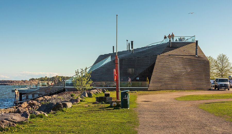 The wooden Löyly sauna building on Hernesaari peninsula in Helsinki, with the Baltic Sea behind