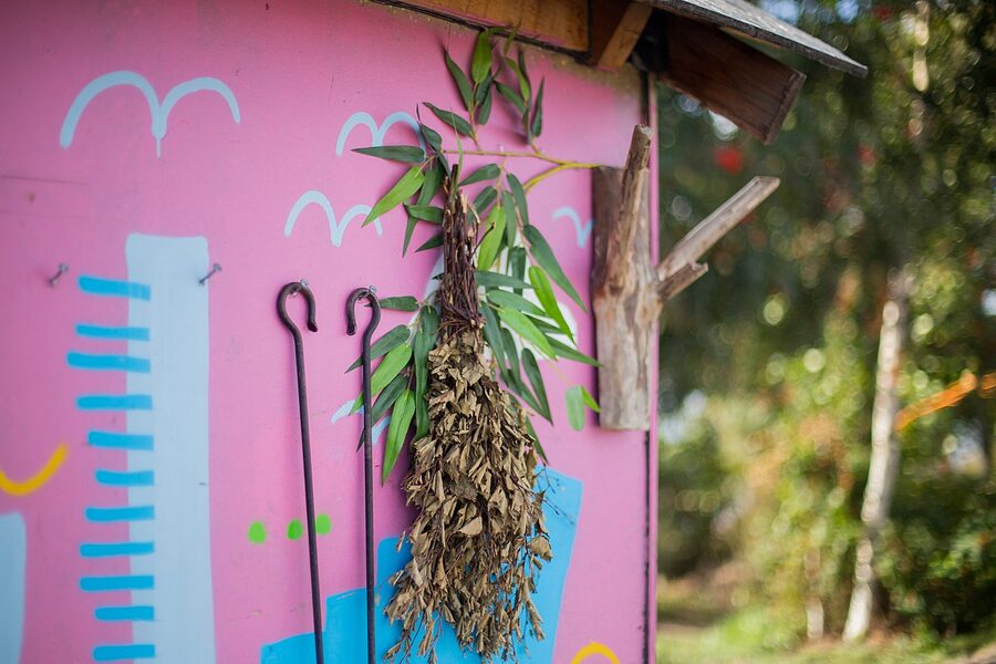 A close-up of a vihta hanging on the wooden door of a Sompasauna shack