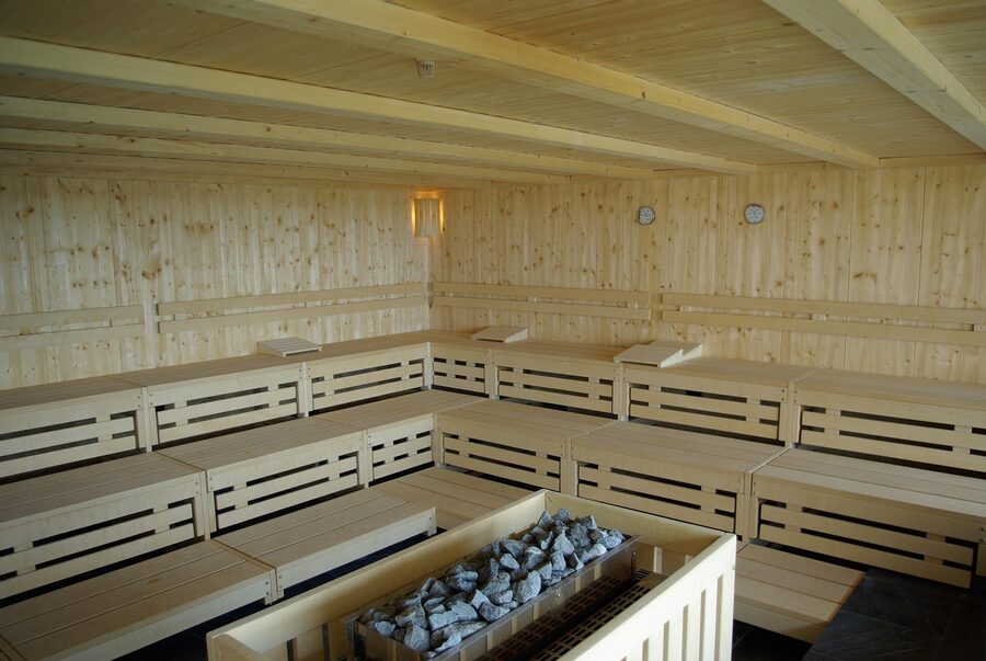 A small wooden Finnish sauna interior, dim and warm
