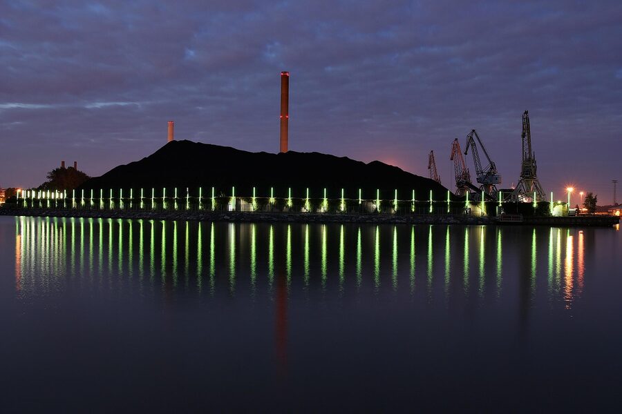 Helsinki cityscape at night with reflections of city lights on water