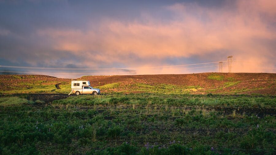 A campervan parked on an Icelandic gravel pull-out at sunset