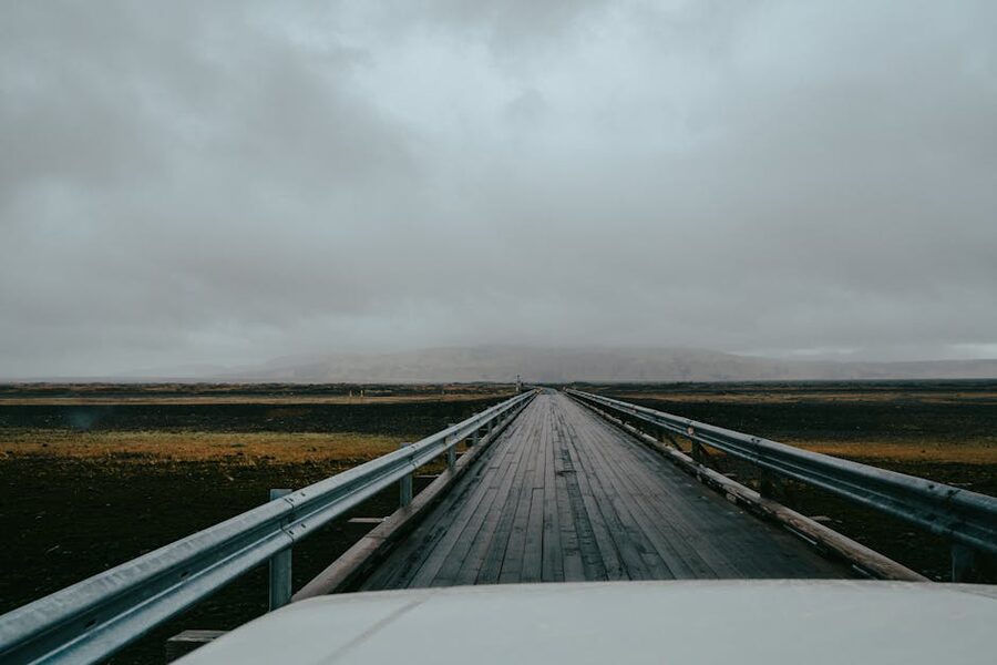 An Icelandic road in late autumn with bare hills and overcast sky