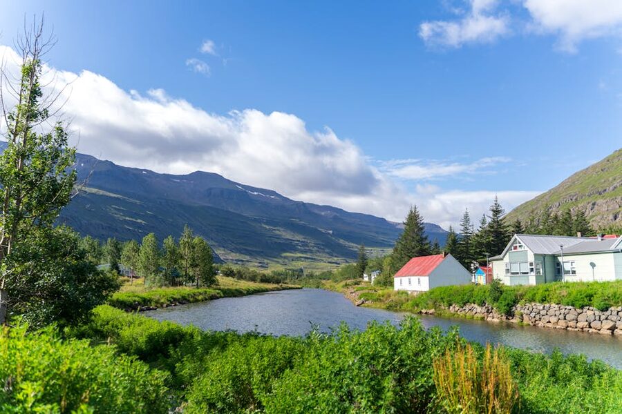 Rainbow-painted street leading to the blue church in Seyðisfjörður