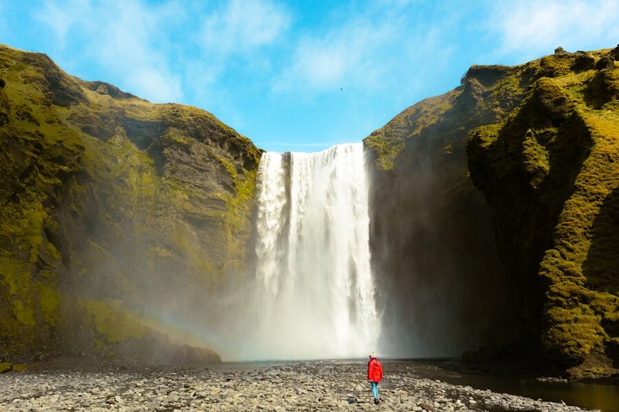 Skogafoss with figure in red coat for scale