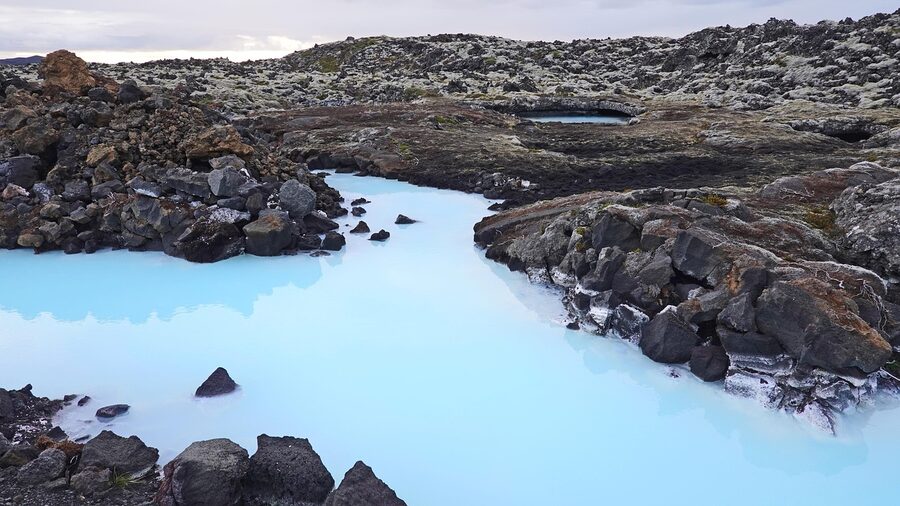 Bathers in geothermal water with steam rising in Iceland