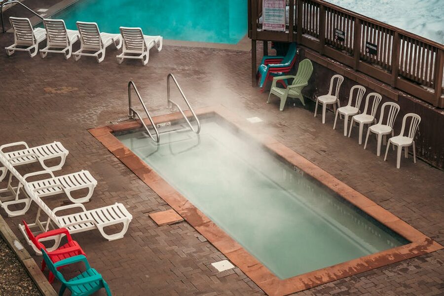 A pool with steam rising in cold weather