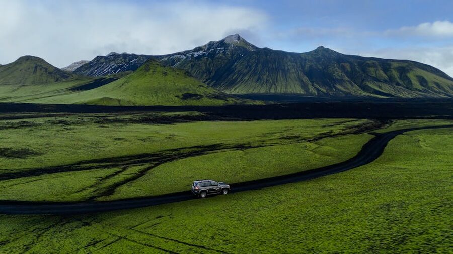 A vehicle on a road through Icelandic highlands