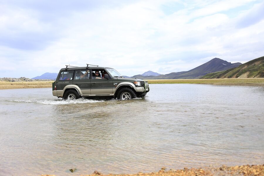A jeep crossing an Iceland river