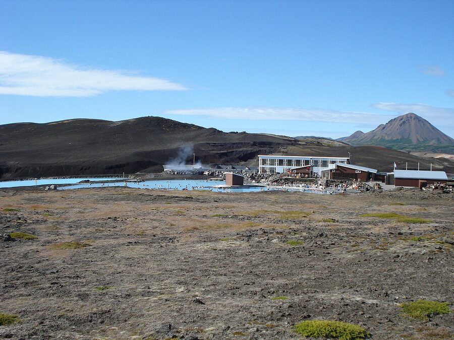 The Mývatn Nature Baths pool in summer with the lava landscape behind