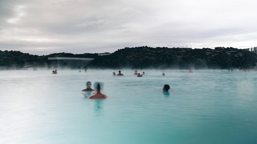 Visitors relaxing in a steaming Icelandic geothermal pool