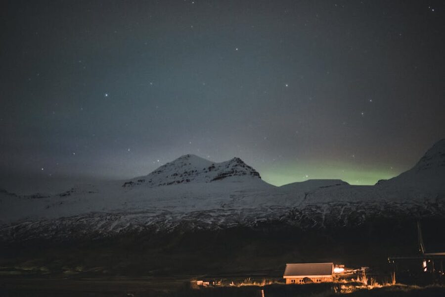 The northern lights over snowy mountains in Iceland