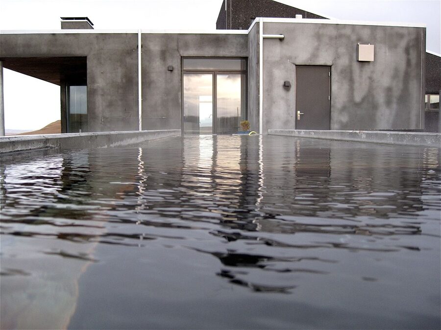 A small geothermal hot pot in Iceland with steaming water at sunset